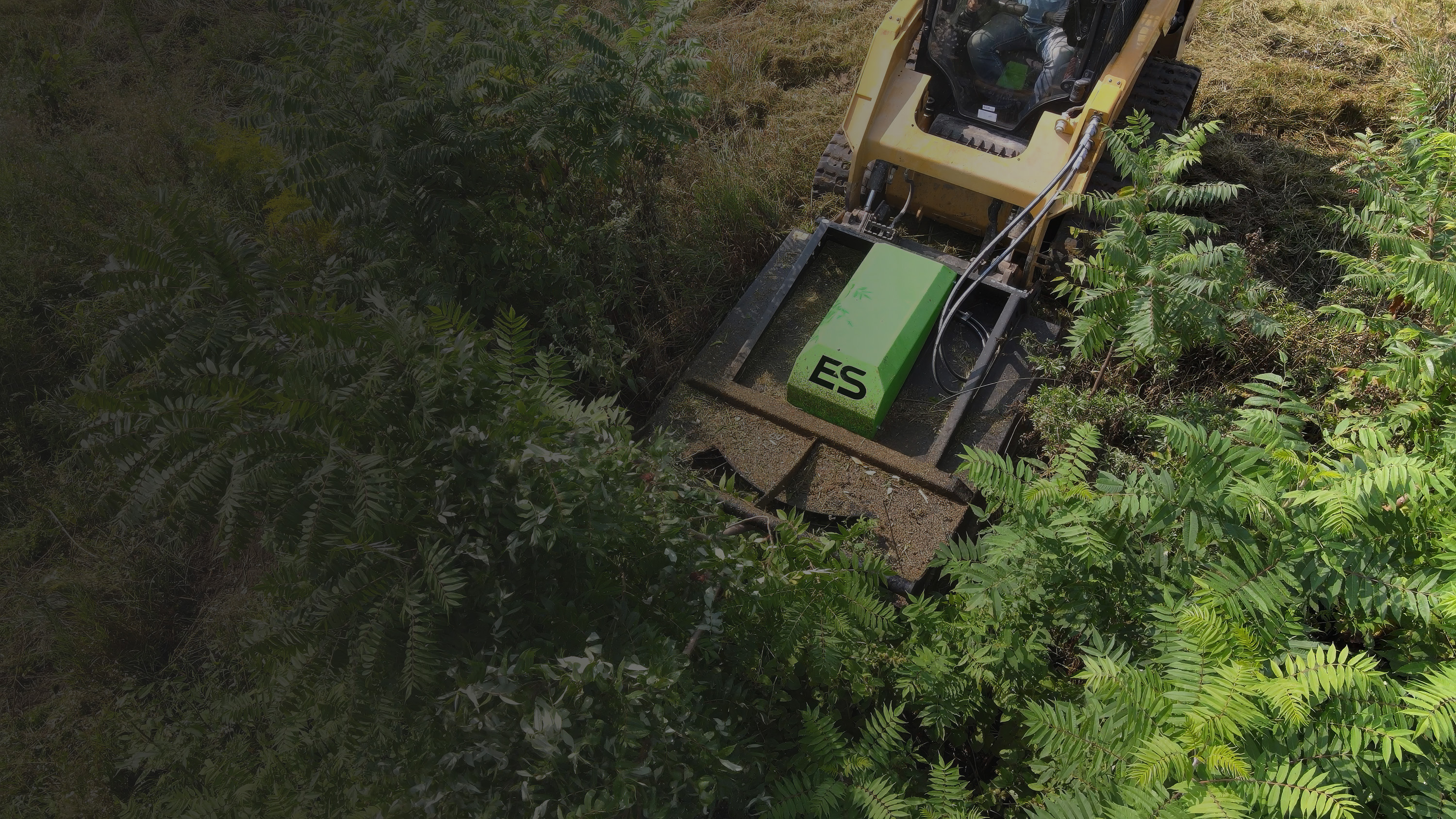 ES Attachments heavy-duty skid steer attachment in use on a jobsite.